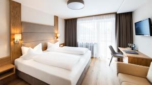 Un pat sau paturi într-o cameră la Hotel Elisabeth