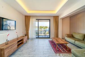 a living room with a couch and a table at Nakas Suites in Fethiye