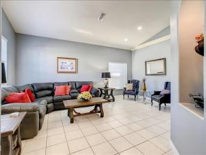 a living room with a couch and a table at 06MS home in Orlando