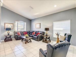 a living room with a couch and chairs in it at 06MS home in Orlando