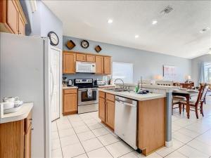 a kitchen with white appliances and a table in it at 06MS home in Orlando