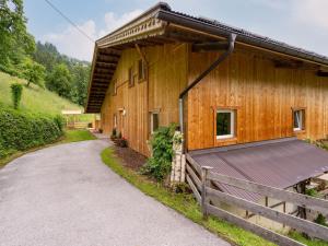 a large wooden building with a fence next to a road at Apartment Talbach - MHO777 by Interhome in Laimach