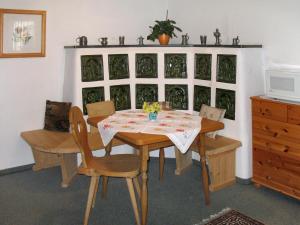 a dining room with a table and chairs and a dresser at Apartment Eusch by Interhome in Viehhofen