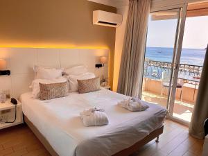 een hotelkamer met een bed met handdoeken erop bij Best Western Plus La Corniche in Toulon