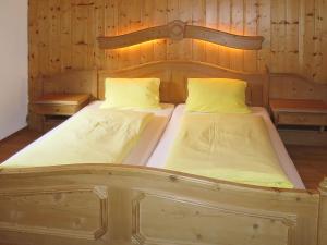 two twin beds in a room with wooden walls at Holiday Home Jagdhaus Strengen - SNN100 by Interhome in Oberriefen