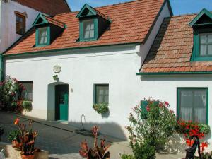 a white house with a red roof at Holiday Home Hofgasse - MOE112 by Interhome in Mörbisch am See