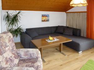 a living room with a couch and a table at Holiday Home Katharina by Interhome in Gröbming
