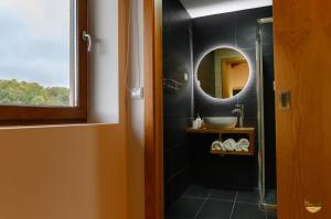 a bathroom with a sink and a mirror at PureAzibo in Macedo de Cavaleiros