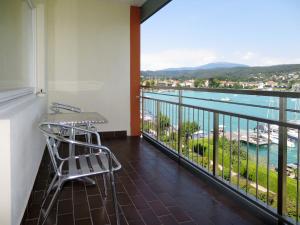 a balcony with a view of the ocean at Apartment Seecorso - VEL205 by Interhome in Velden am Wörthersee
