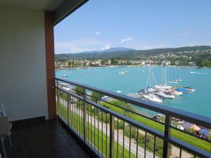 a balcony with a view of the water and boats at Apartment Seecorso - VEL205 by Interhome in Velden am Wörthersee