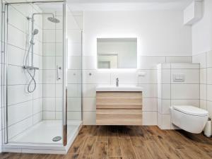 a bathroom with a shower and a sink and a toilet at Apartment Deutschbauer - FAK100 by Interhome in Egg am Faaker See