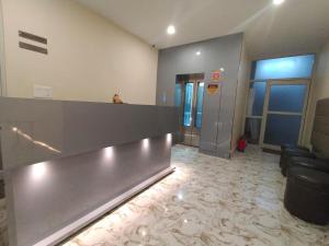 an empty lobby with a reception desk in a building at HOTEL TRIDEV GRAND in Varanasi