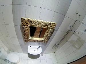 a bathroom with a sink and a mirror on the wall at My Homestay Yogyakarta in Jetis +15 photos