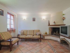 a living room with two couches and a television at Holiday Home Da Franca by Interhome in Stazzema