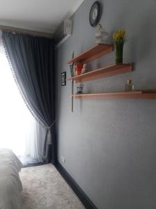 a bedroom with a wall with shelves and a window at Apartment u Lidii in center of Kiev near railways station in Kyiv