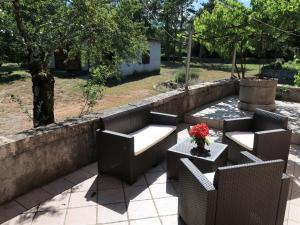 a patio with chairs and a table with a vase of flowers at Holiday Home Nino - LBN305 by Interhome in Kršan