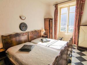 a bedroom with a wooden bed with a checkered floor at Apartment Le Majestic by Interhome in Chamonix