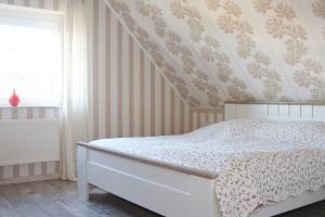 um quarto com uma cama com papel de parede floral em Alles, außer gewöhnlich em Steinbergkirche