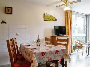 a dining room with a table and a tv at Apartment Arve 1 et 2-1 by Interhome in Chamonix-Mont-Blanc