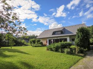 a house with a yard with green grass at Apartment Eckel-1 by Interhome in Russbach