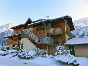 a snow covered building with a balcony on a mountain at Studio Les Chamois by Interhome in Les Houches