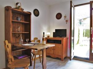 a dining room with a table with a bottle of wine at Studio Les Chamois by Interhome in Les Houches