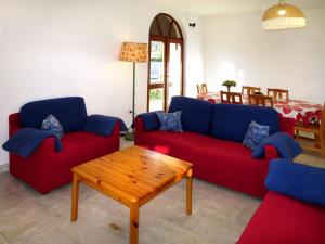 a living room with two red and blue couches and a table at Holiday Home Julija - VOD300 by Interhome in Pirovac