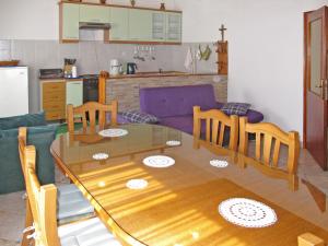 a kitchen and dining room with a wooden table and chairs at Holiday Home Vesna - ZAD105 by Interhome in Diklo