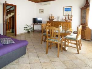 a living room with a table and chairs and a couch at Holiday Home Vesna by Interhome in Diklo
