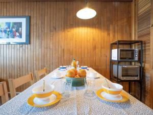 a table with a bowl of fruit and a microwave at Apartment Le Grand Tichot A et B-2 by Interhome in Tignes