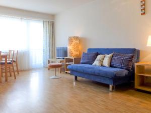 - un salon avec un canapé bleu et une table dans l'établissement Apartment Beaulieu-2 by Interhome, à Zermatt