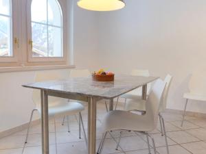 a dining room table with a bowl of fruit on it at Apartment Obri Tuftra-4 by Interhome in Zermatt