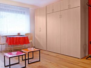 a room with white cabinets and a table and two tables at Apartment Viscaria-2 by Interhome in Zermatt