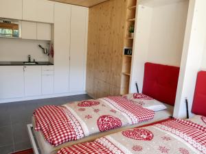two beds in a room with red and white blankets at Apartment Rosablanche D52 by Interhome in Siviez +23 photos