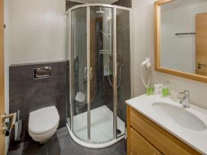 a bathroom with a shower and a toilet and a sink at Apartment Zur Matte B-1 by Interhome in Zermatt