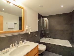 a bathroom with a sink and a toilet and a tub at Apartment Zur Matte B-2 by Interhome in Zermatt
