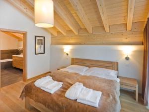 a bedroom with a large bed with towels on it at Apartment Zur Matte B-9 by Interhome in Zermatt
