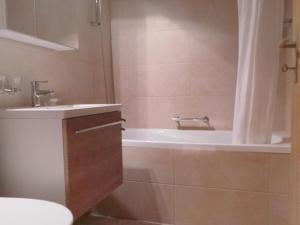 ein Badezimmer mit einer Badewanne, einem WC und einem Waschbecken in der Unterkunft Apartment Select by Interhome in Zermatt