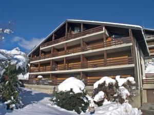 a large building in the snow with snow at Apartment Centaure B RS 2 by Interhome in Ovronnaz