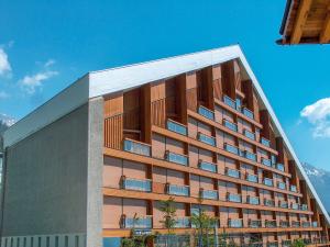 a tall building with a lot of windows at Apartment Les Mischabels-1 by Interhome in Crans-Montana