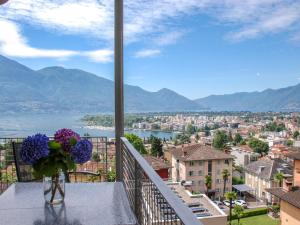 a vase of flowers sitting on a table on a balcony at Apartment Condominio Collina in Muralto