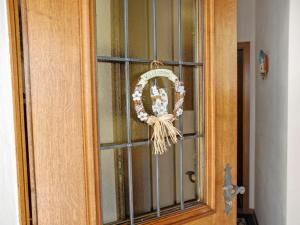 a door of a cabinet with a wreath on it at Apartment Casa tre G - App OG by Interhome in Losone