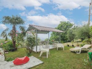 a garden with a gazebo and chairs at Apartment Del Freo by Interhome in Montignoso