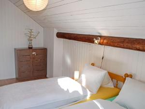 a bedroom with a bed and a dresser at Holiday Home Marianne Plus by Interhome in Aquila +12 photos