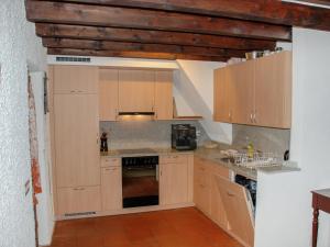 a kitchen with wooden cabinets and an oven at Holiday Home Marianne Plus by Interhome in Aquila