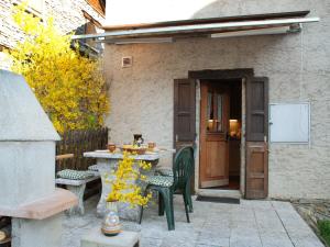 a patio with a table and chairs in front of a building at Holiday Home Marianne by Interhome in Aquila