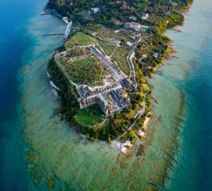 an aerial view of an island in the water at La Lampara in Sirmione