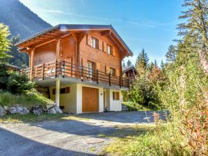 a large wooden house with a balcony at Chalet Miranda by Interhome in Champex