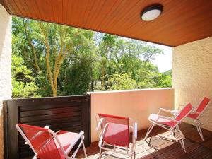 a group of chairs sitting on a deck at Apartment Airial by Interhome in Seignosse