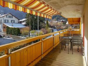 a balcony with a table and chairs and a view at Apartment Oberei by Interhome in Wilderswil